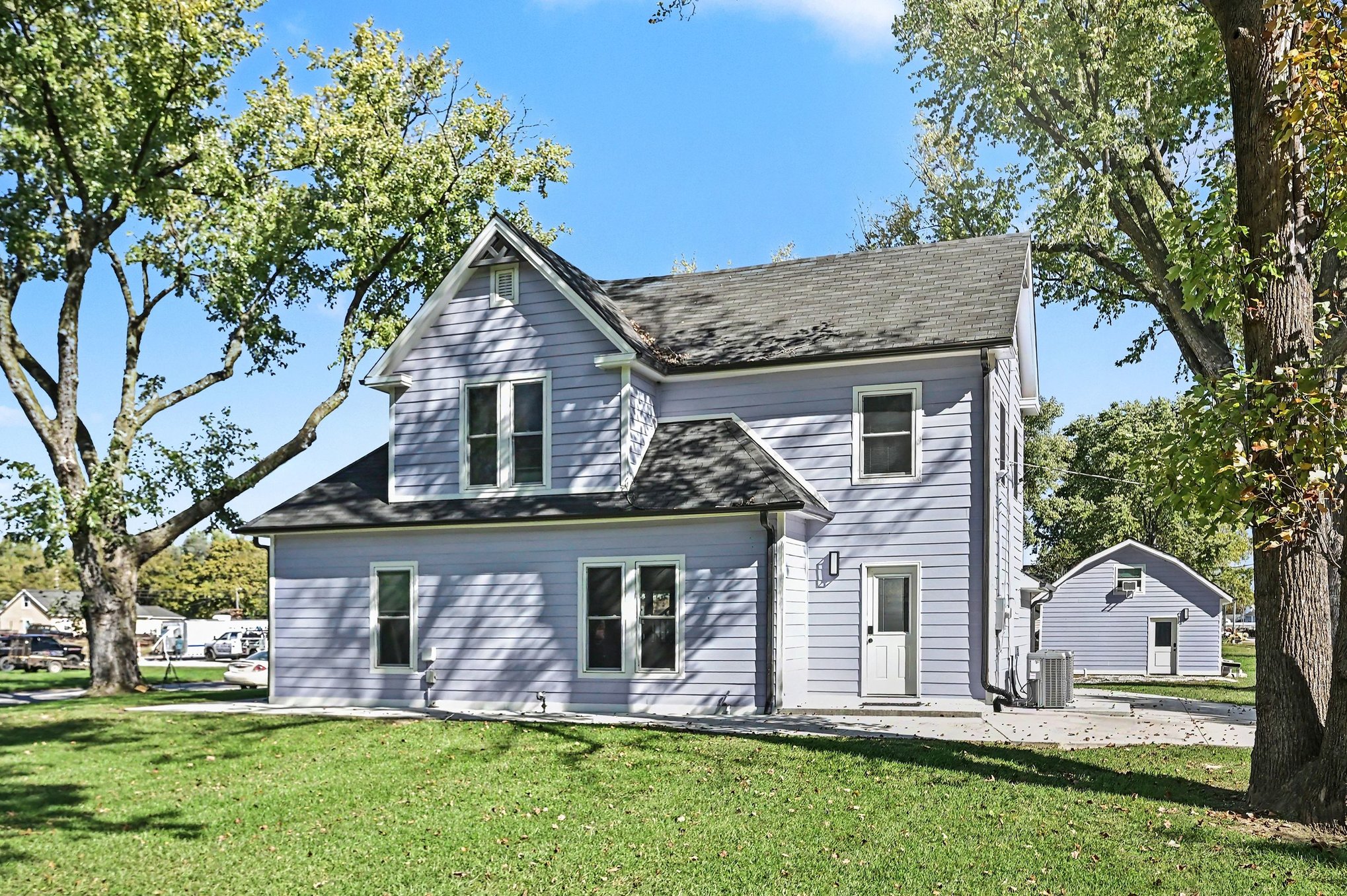 Rear of the farmhouse with patio and guest house to the side