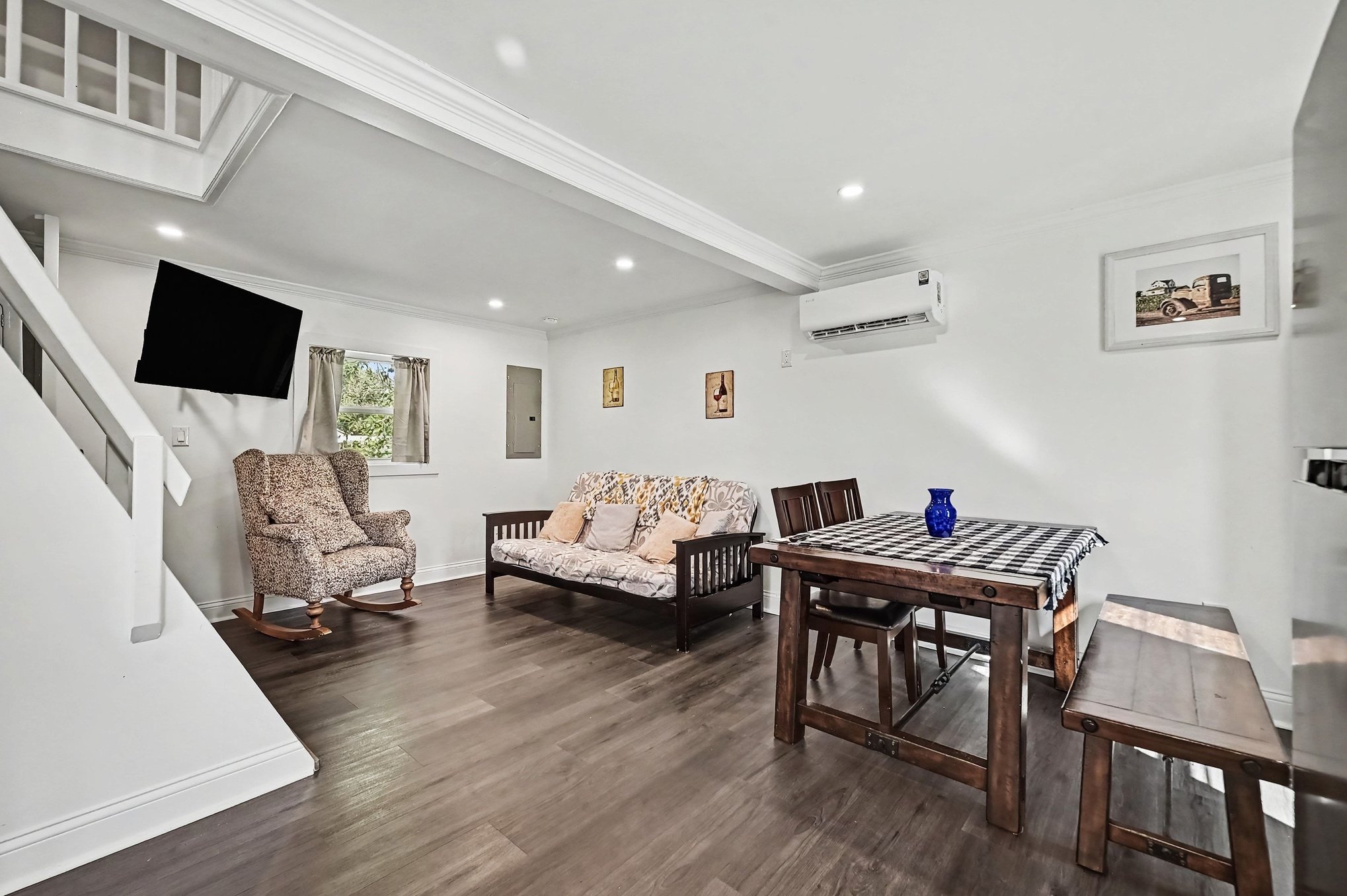 Guest house living and dining room with ductless mini-split, recessed lighting and stairs to the loft bedroom