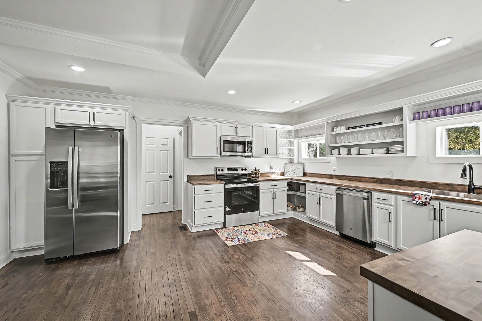 Kitchen with side-by-side refrigerator and coffered tray ceiling