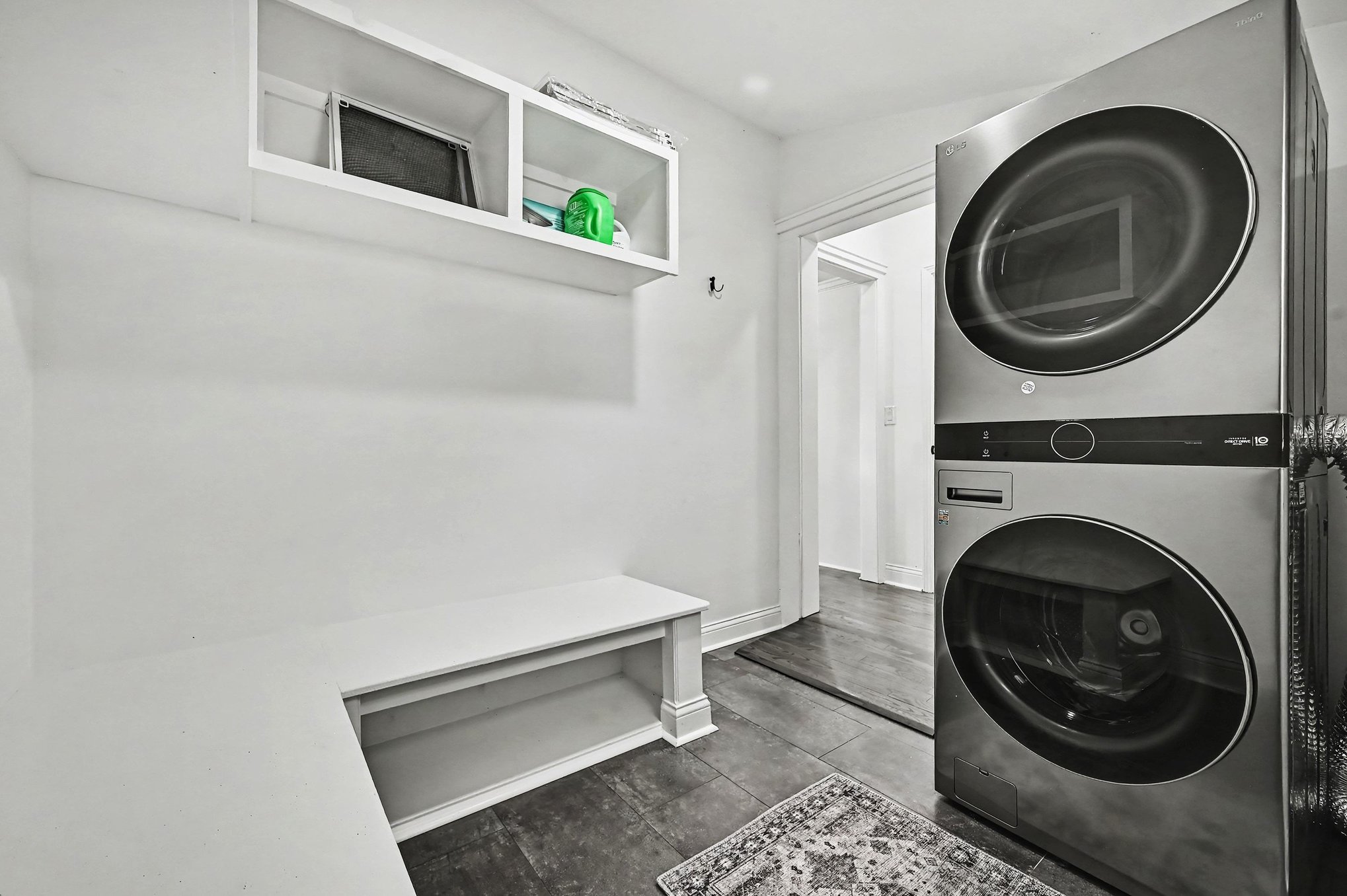Main-level laundry and mudroom with stacked washer and dryer