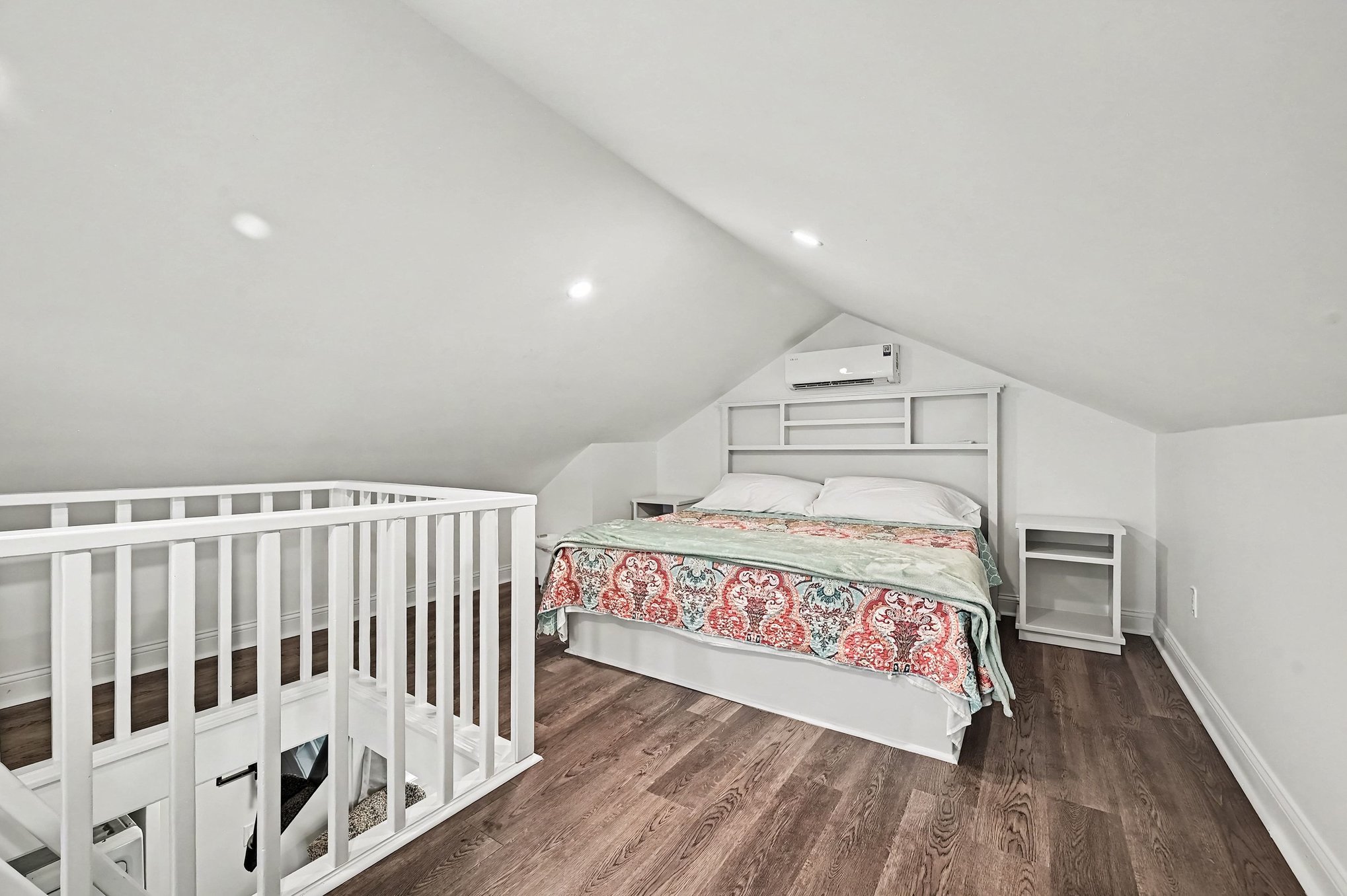 Guest house vaulted loft bedroom with king bed, built-in headboard and ductless mini-split