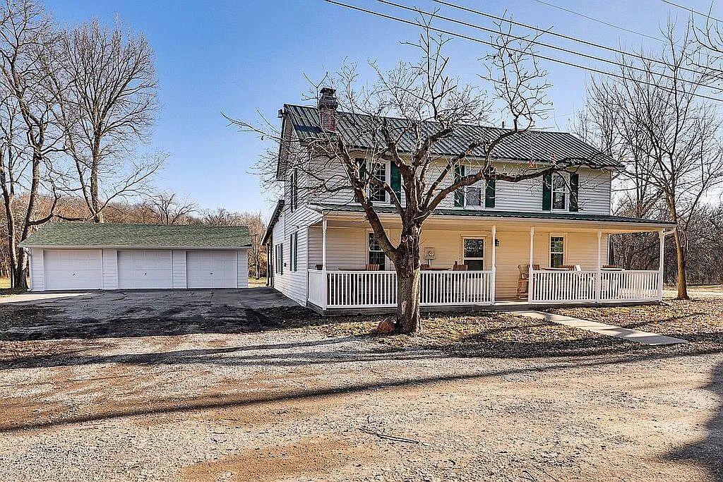 485 Waters St Holt MO farmhouse for sale with wraparound porch, metal roof and detached 3-car garage
