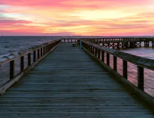 alt="A scenic waterfront view of the Chesapeake Bay from the fishing pier at Downs Park in Pasadena, MD."