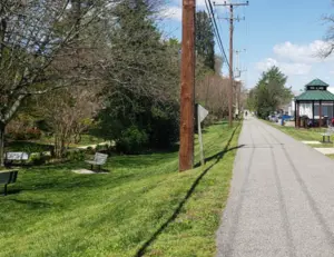 alt="People biking on the scenic, tree-lined B&A Trail as it passes through Severna Park, MD."