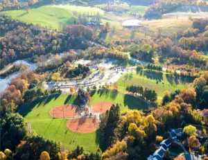 alt="A family enjoying the playground and scenic lake at Centennial Park, a popular destination in Ellicott City, MD."