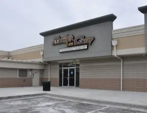 alt="A family playing on the glowing, monster-themed indoor course at Monster Mini Golf, a fun attraction serving the Jessup, MD area."