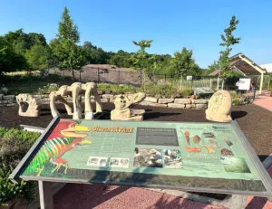 alt="A family searching for fossils at Dinosaur Park, a unique and educational family attraction in Laurel, MD."