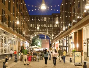 alt="A bustling street scene at Bethesda Row, a premier open-air destination for shopping and dining in Bethesda, MD."
