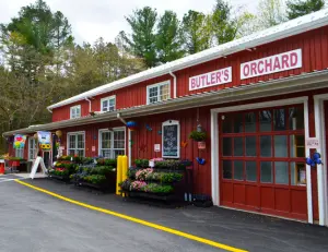 alt="A family picking fresh strawberries at Butler's Orchard, a popular farm and market in Germantown, MD."