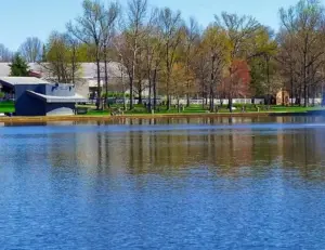 alt="A scenic view of the large pond and walking trail at Allen Pond Park, a central community hub in Bowie, MD."