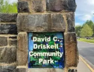 alt="Children playing on the unique, art-themed playground at David C. Driskell Community Park in Hyattsville, MD."