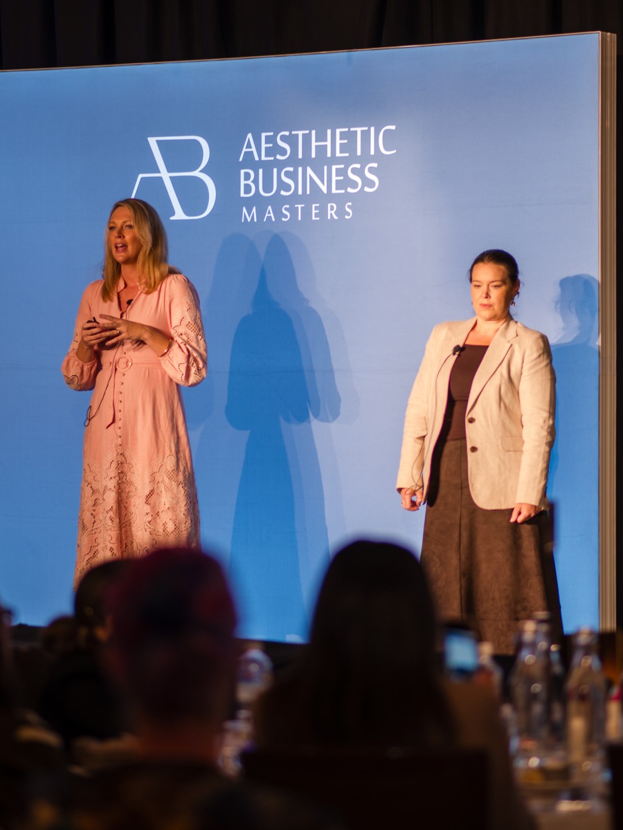 Kelly and Alicia on stage with the audience in the foreground