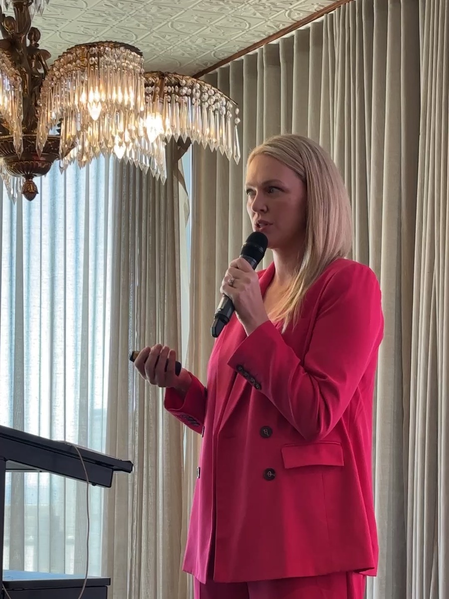 Alicia Hagen speaking to a conference room