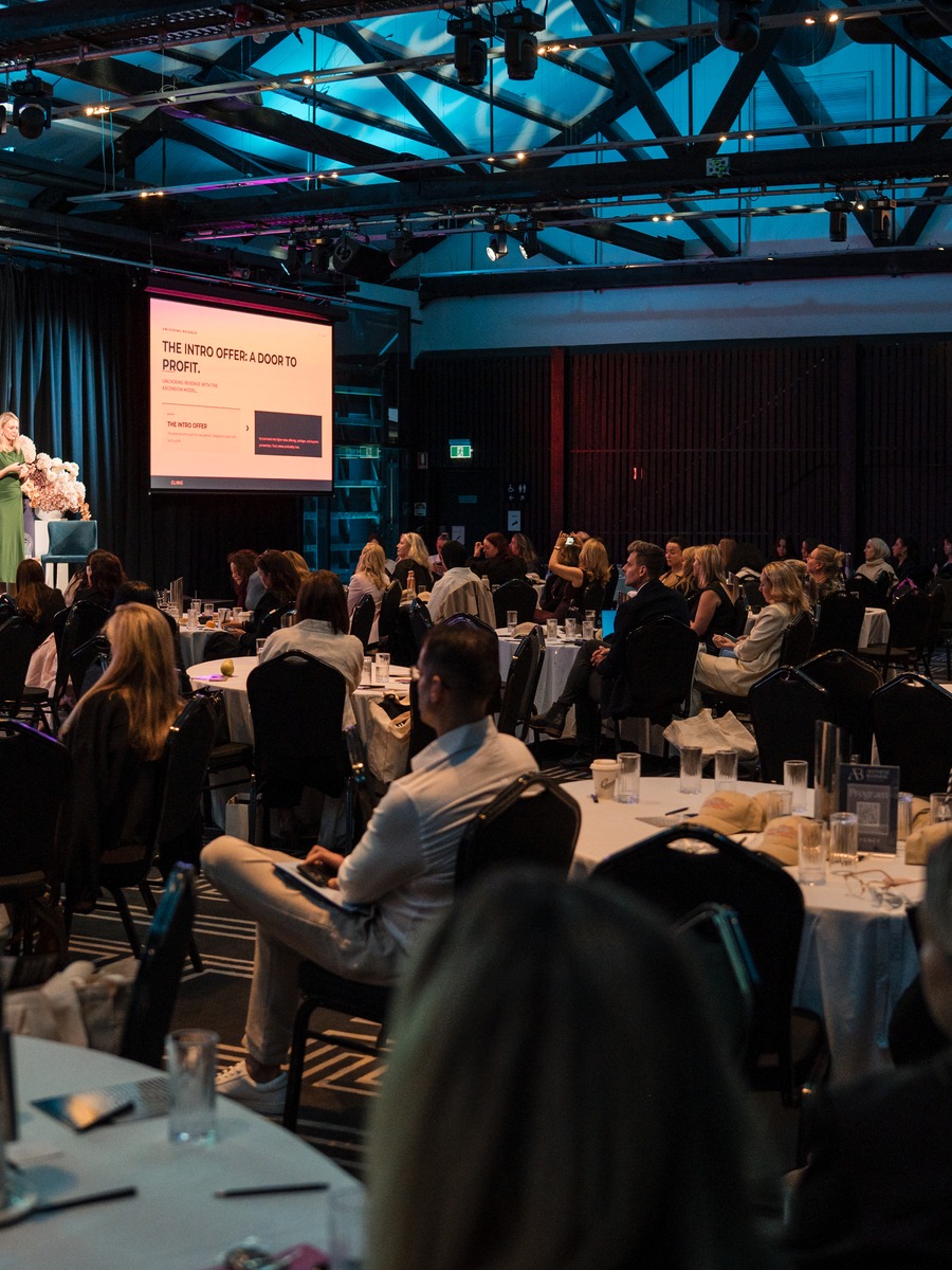 A full room of clinic owners at an industry conference