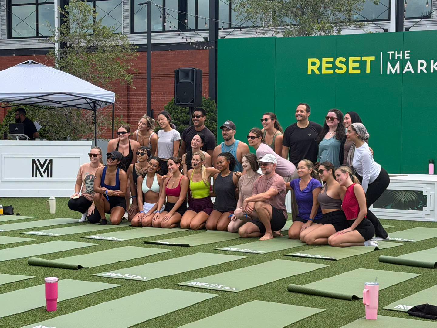 Jenny with a smiling group of participants after leading yoga at a corporate wellness event