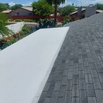 Coated low-slope run meeting a finished shingle field