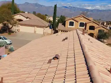 Tile roof with neighboring homes and the mountains behind