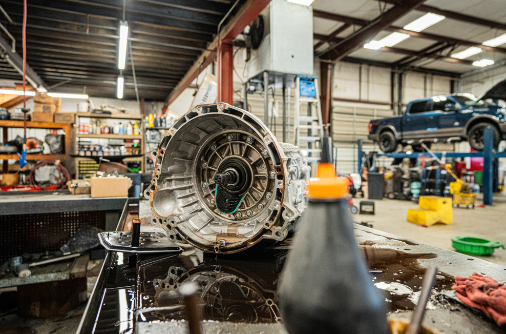 Transmission assembly inside an auto repair shop