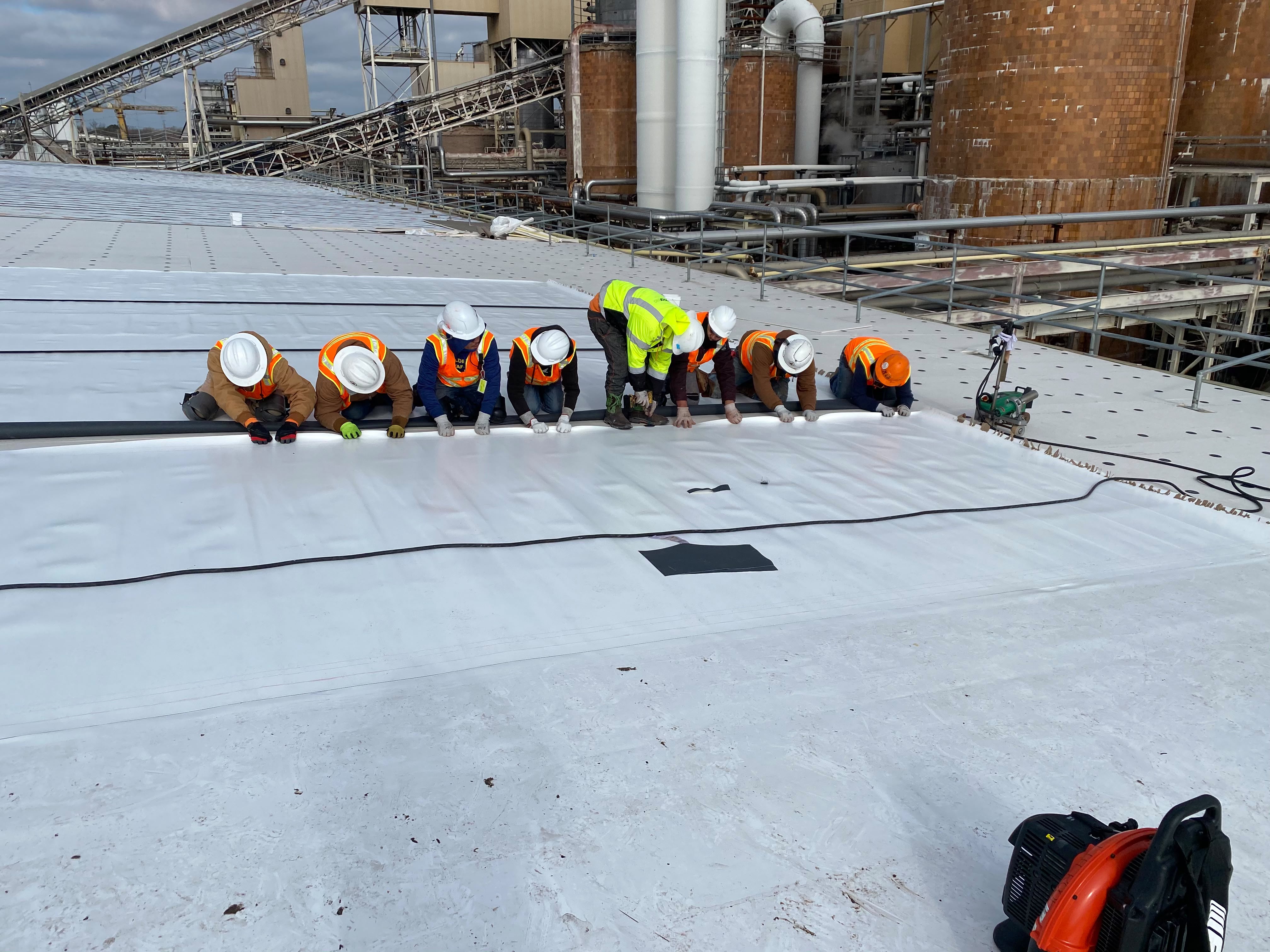 Professional roofer working on a commercial building
