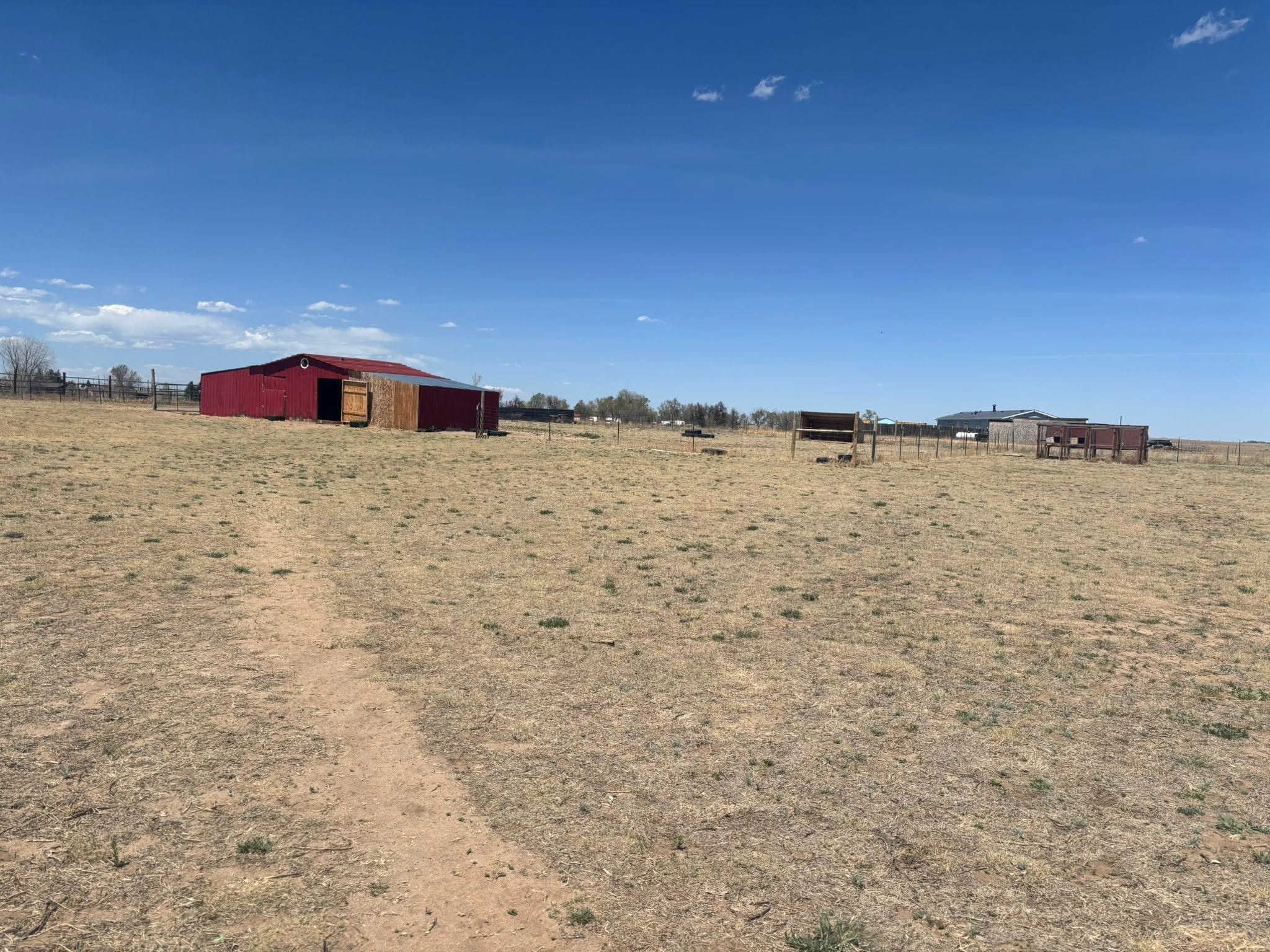 Red barn and cross-fencing on acreage east of Colorado Springs