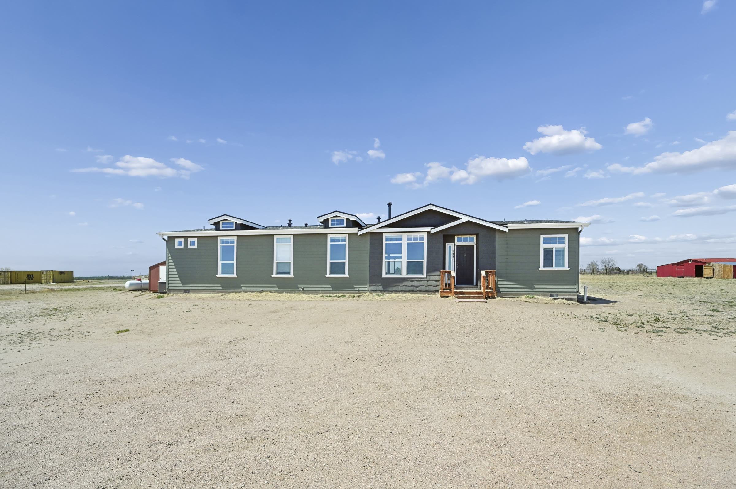 Sage-green single-story home on acreage east of Colorado Springs