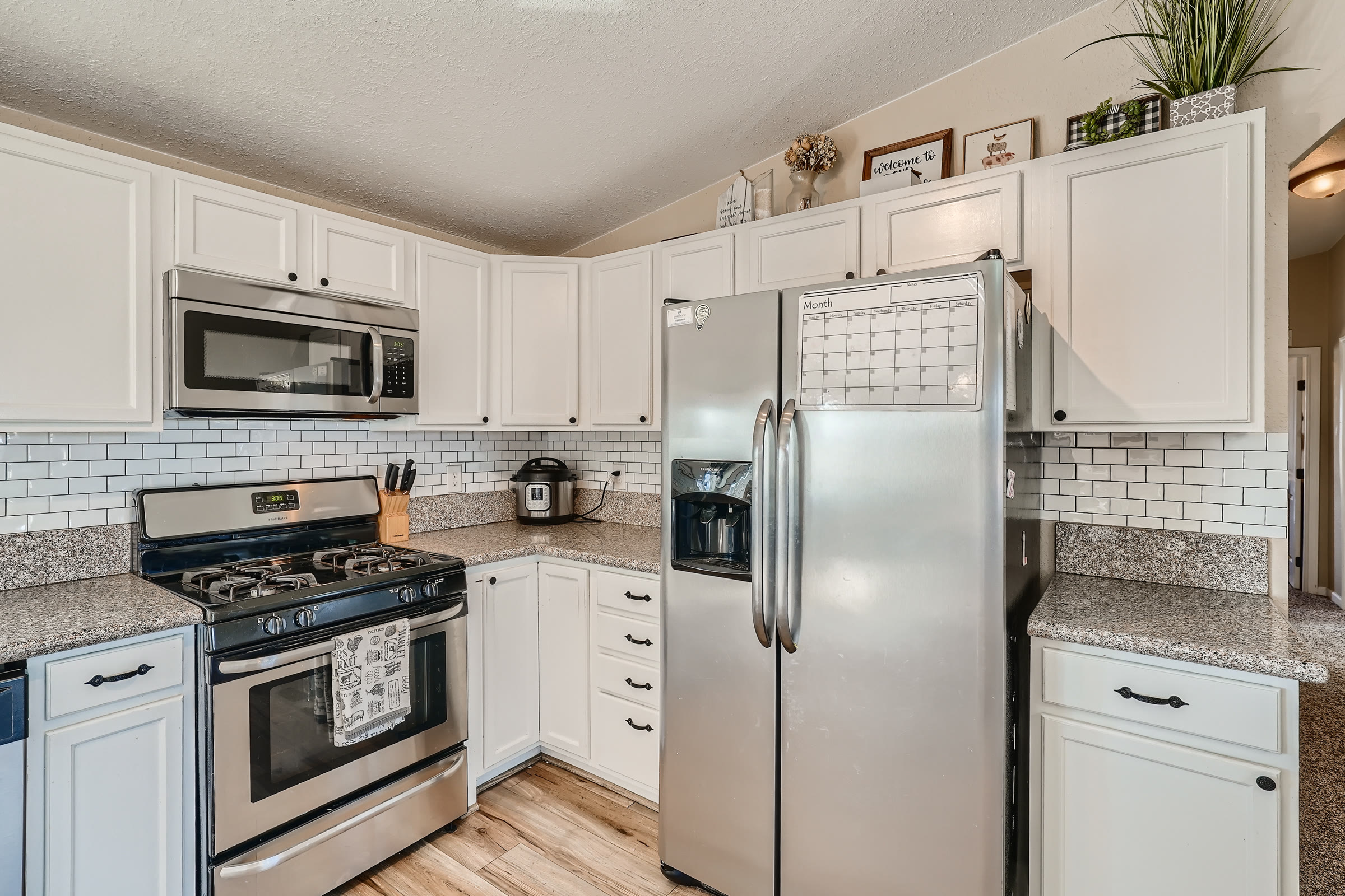 Bright kitchen with white cabinets and subway tile in a Colorado Springs area home