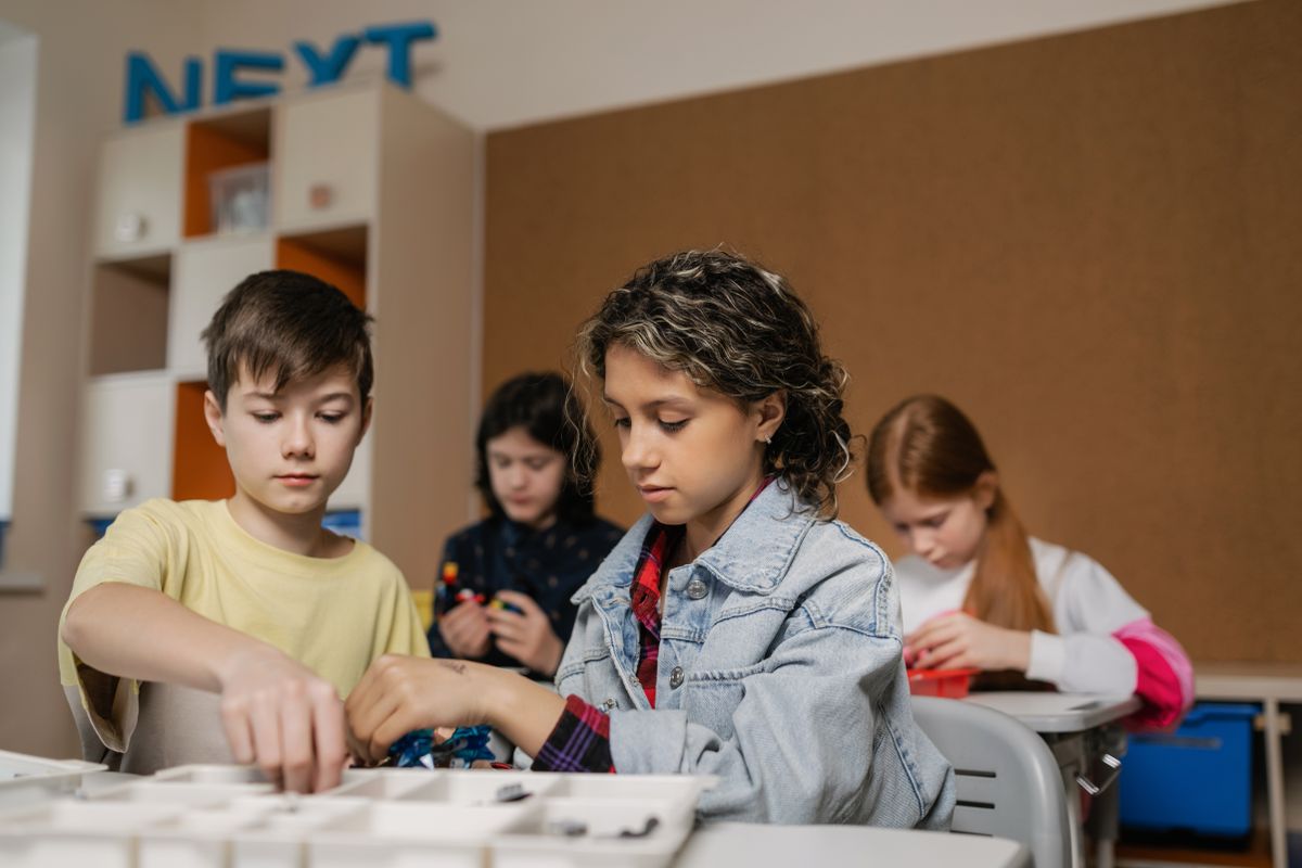 Students building with bricks in class