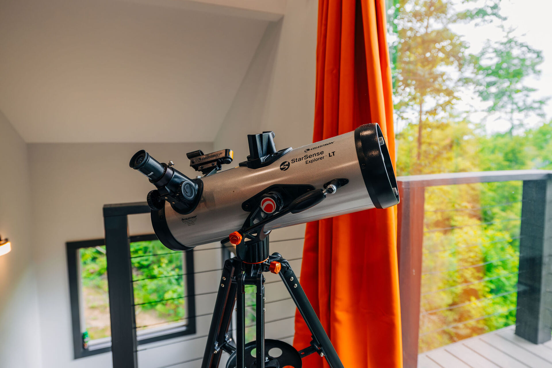 Telescope pointed at the treetops from inside The Onyx