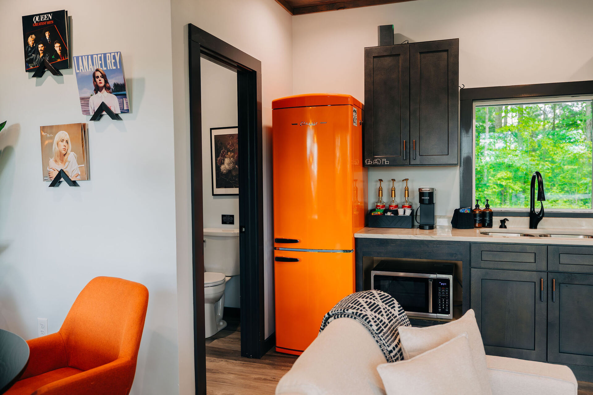 The Onyx kitchen with bold orange backsplash