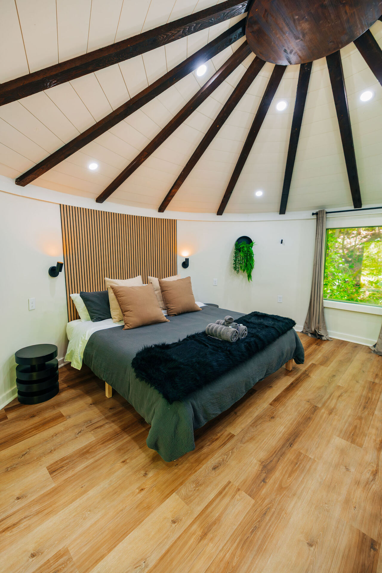 Round living room inside the silo with radial ceiling beams