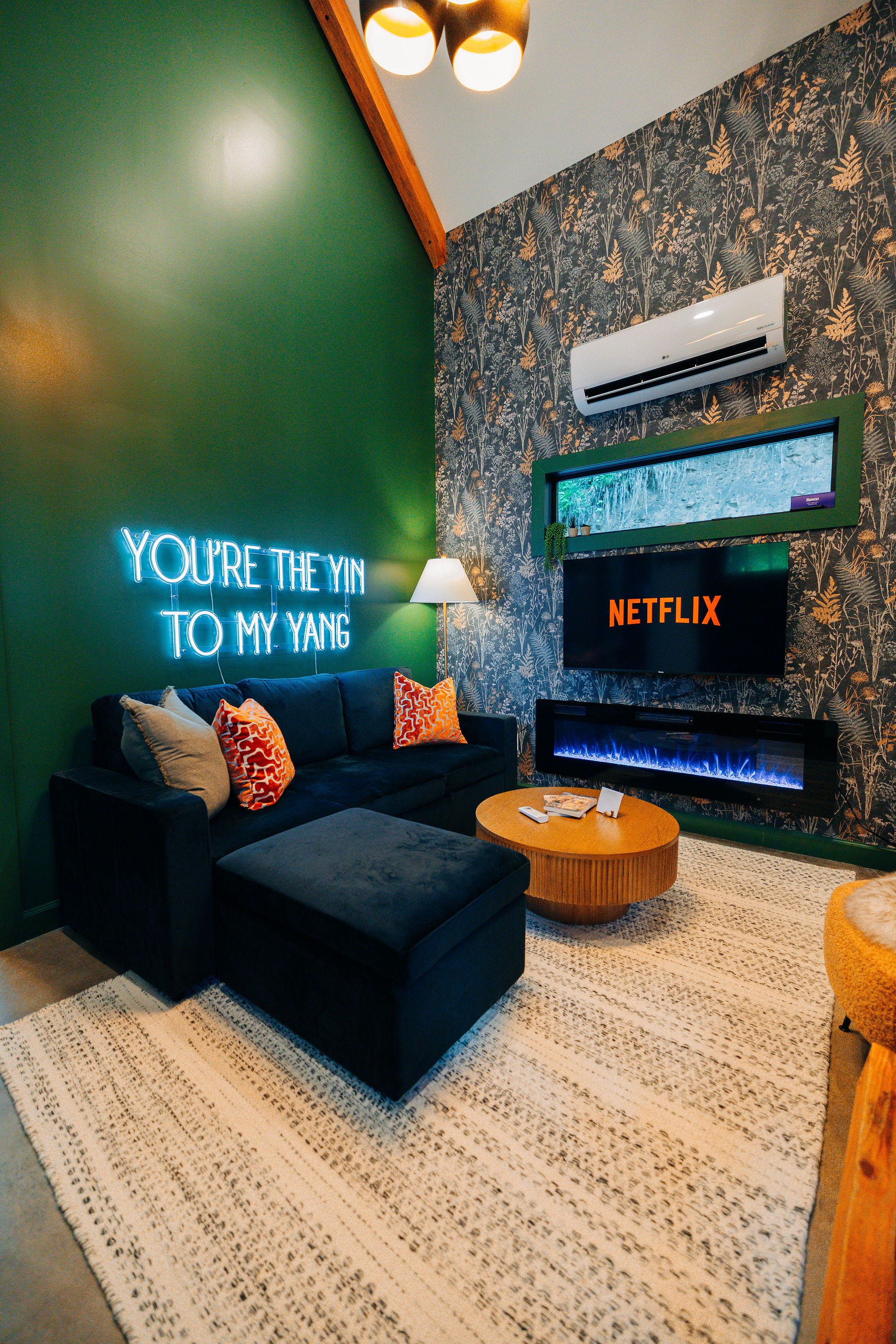 Cozy cabin living room with neon sign and fireplace