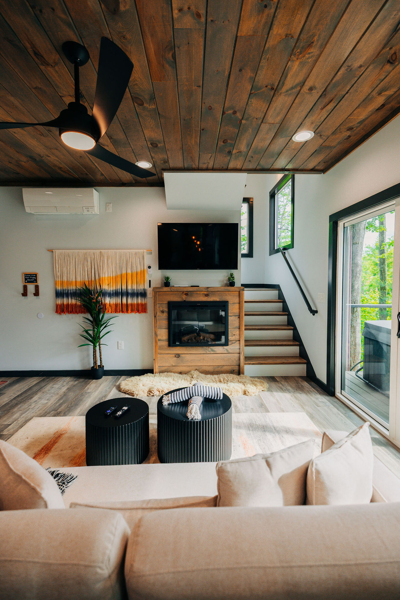Living room at The Onyx with warm wood ceiling and amber accents