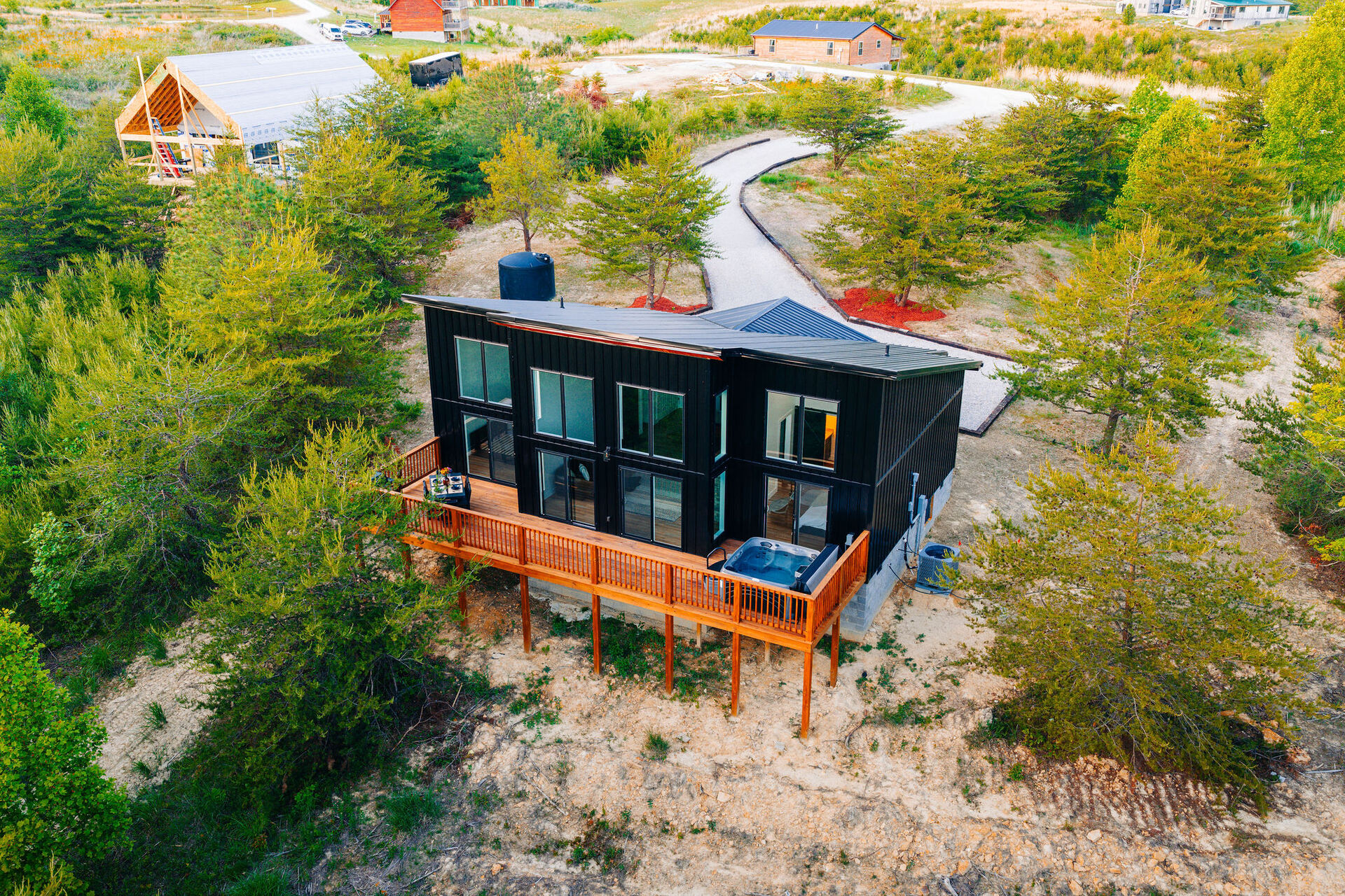 Aerial view of The Blackstone cabin above emerald quarry water