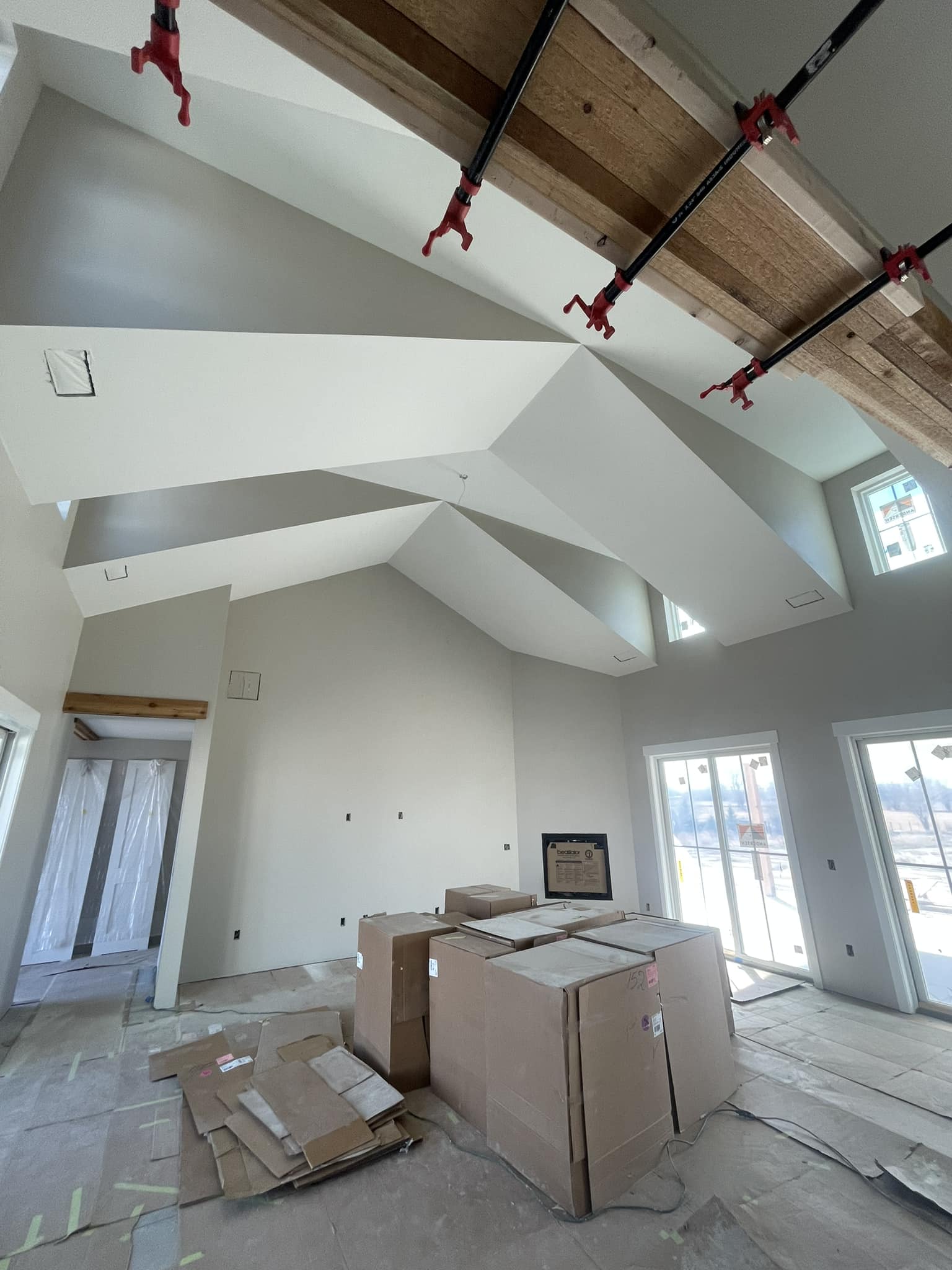 residential interior paint job on a newly constructed house with high vaulted ceilings.