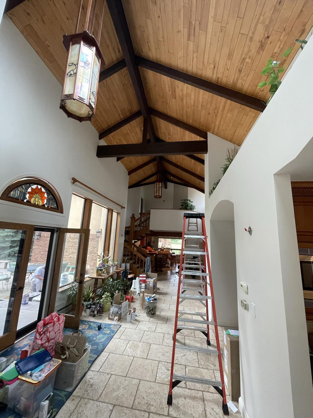 interior paint job with wood beams, trim, and arches