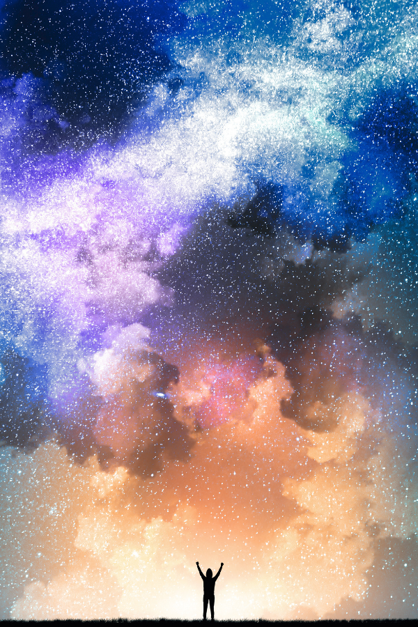 empowered person standing under vast sunset and starry night