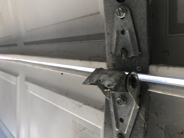 Broken garage door hinges and hardware