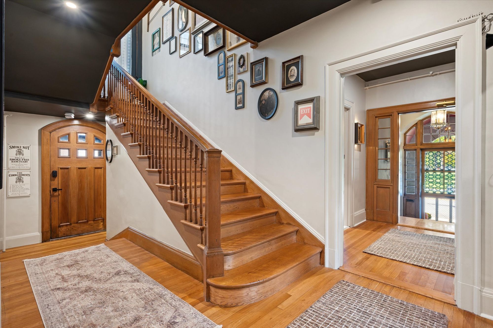 The oak staircase and gallery wall at One Lincoln Ave