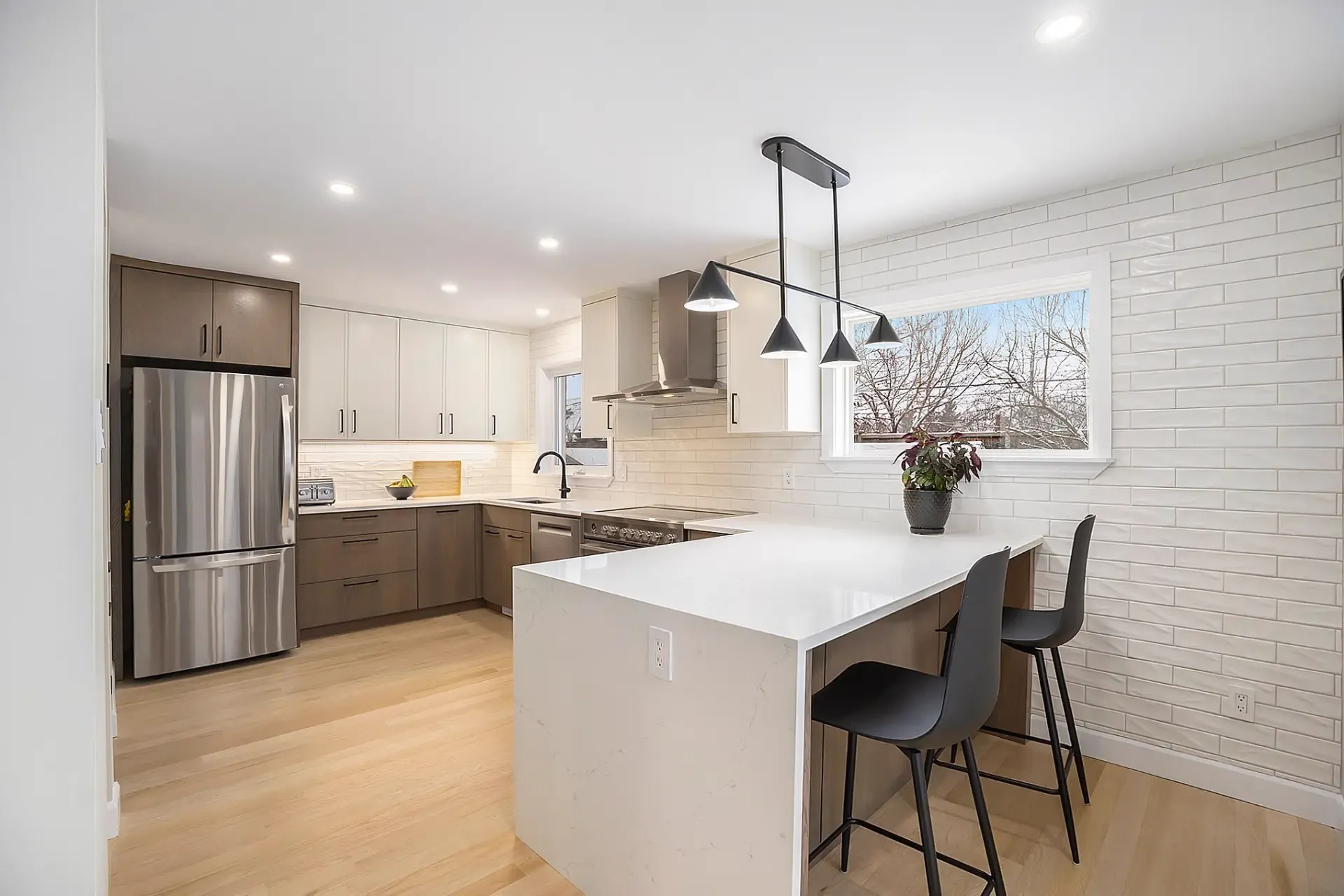 Custom kitchen renovation with waterfall island and modern backsplash in Ottawa
