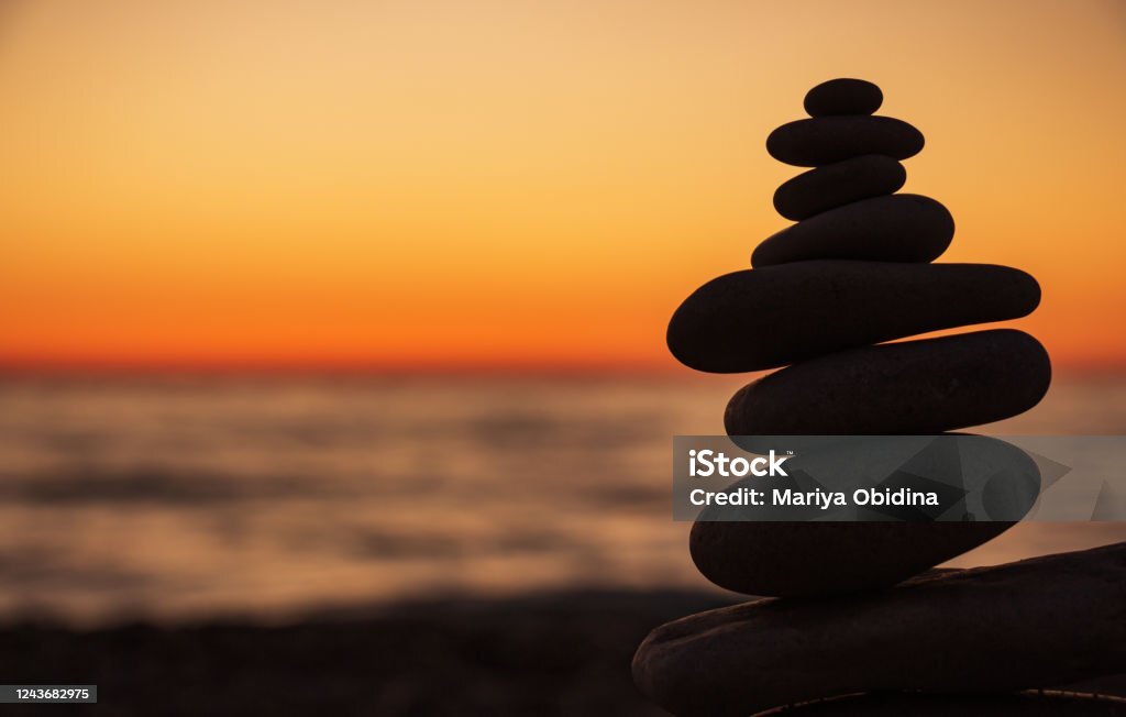 Balanced zen stones at sunset