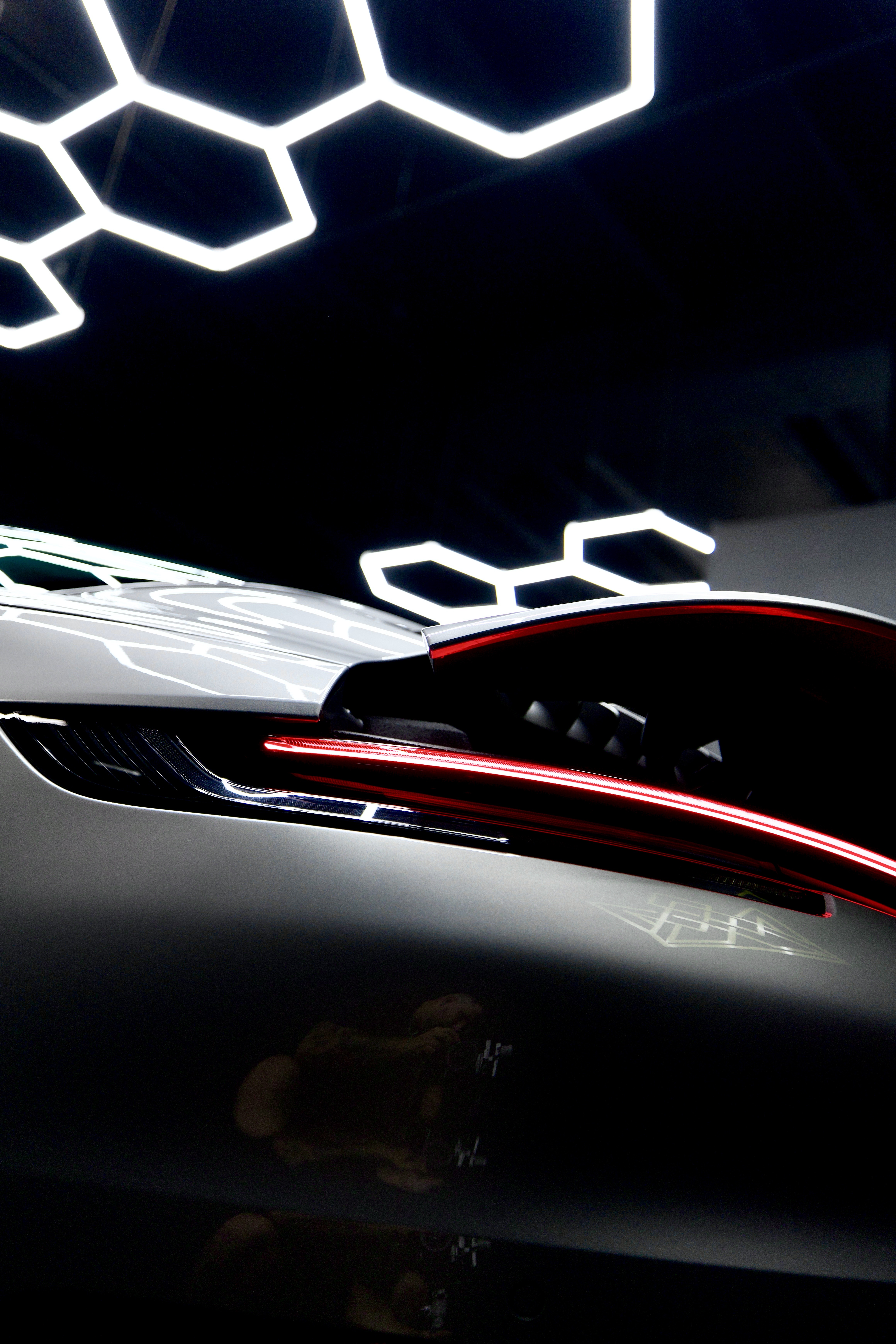 Porsche rear paint and spoiler detail under the Imperial Auto Lab shop lights