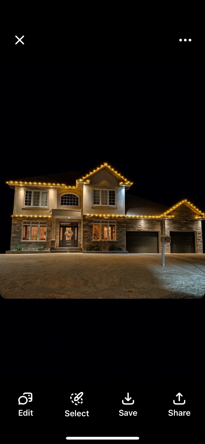 Warm-white C9 Christmas lights following the roofline of a two-storey home