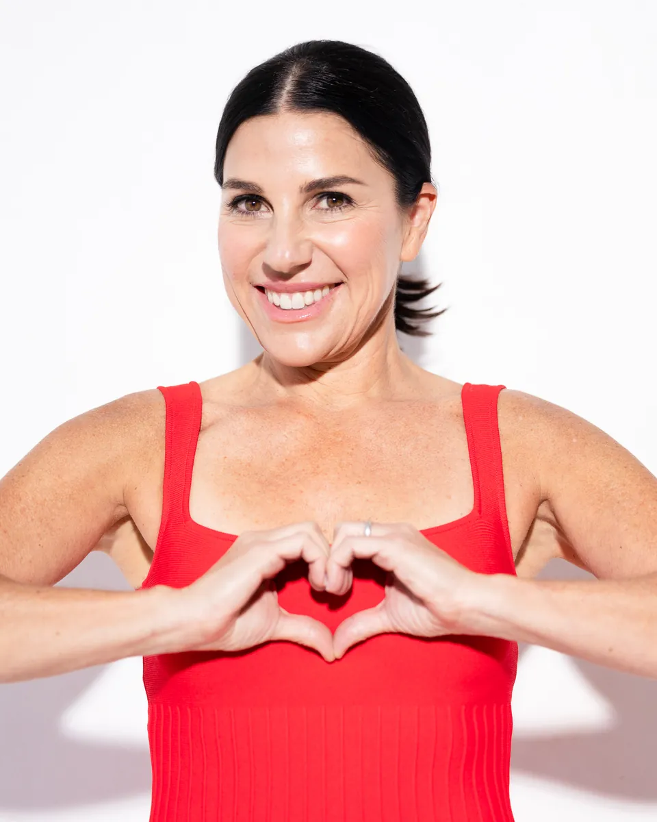 Hilary Silver, founder of Ready for Love, making a heart with her hands