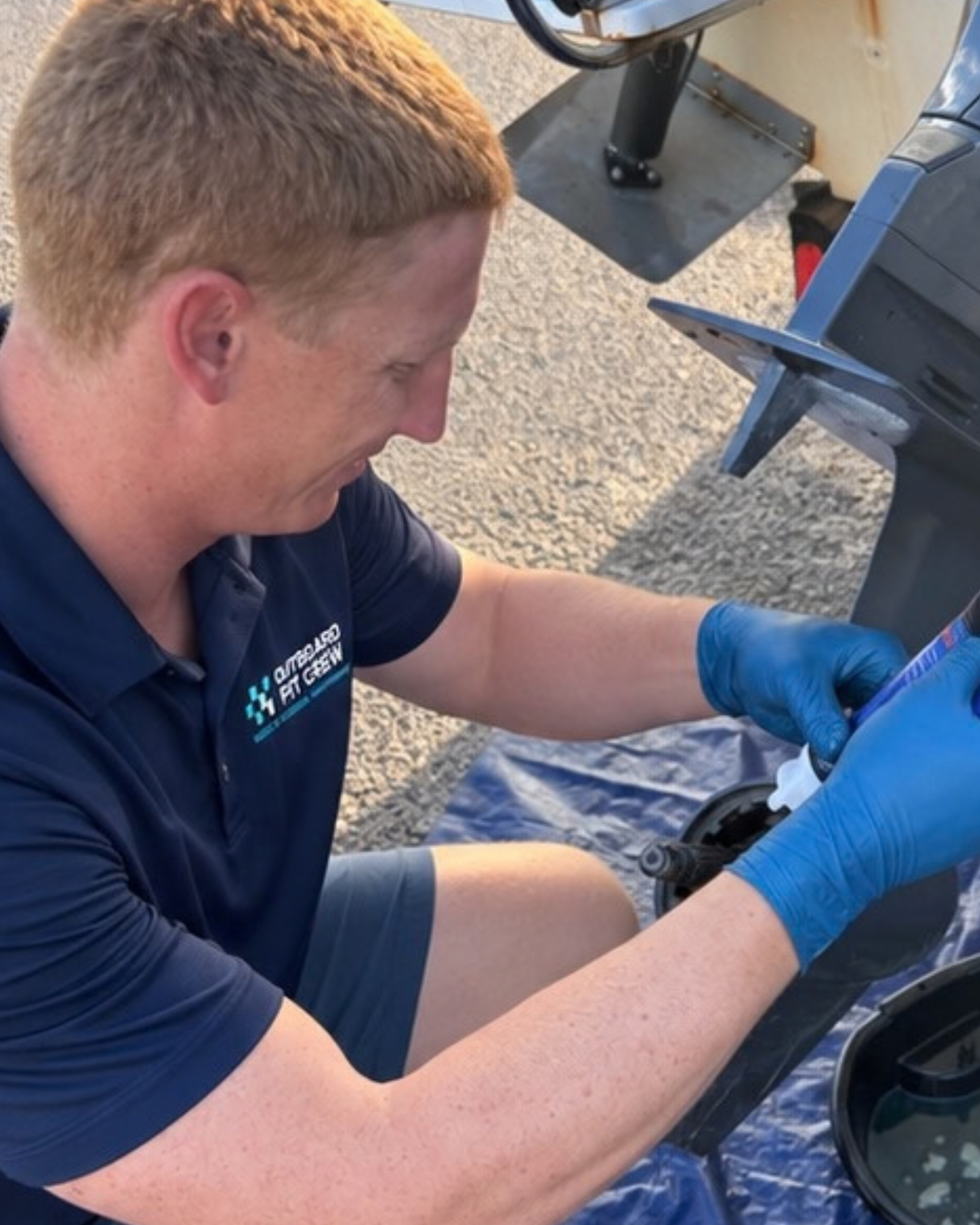 Outboard Pit Crew performing lower-unit maintenance
