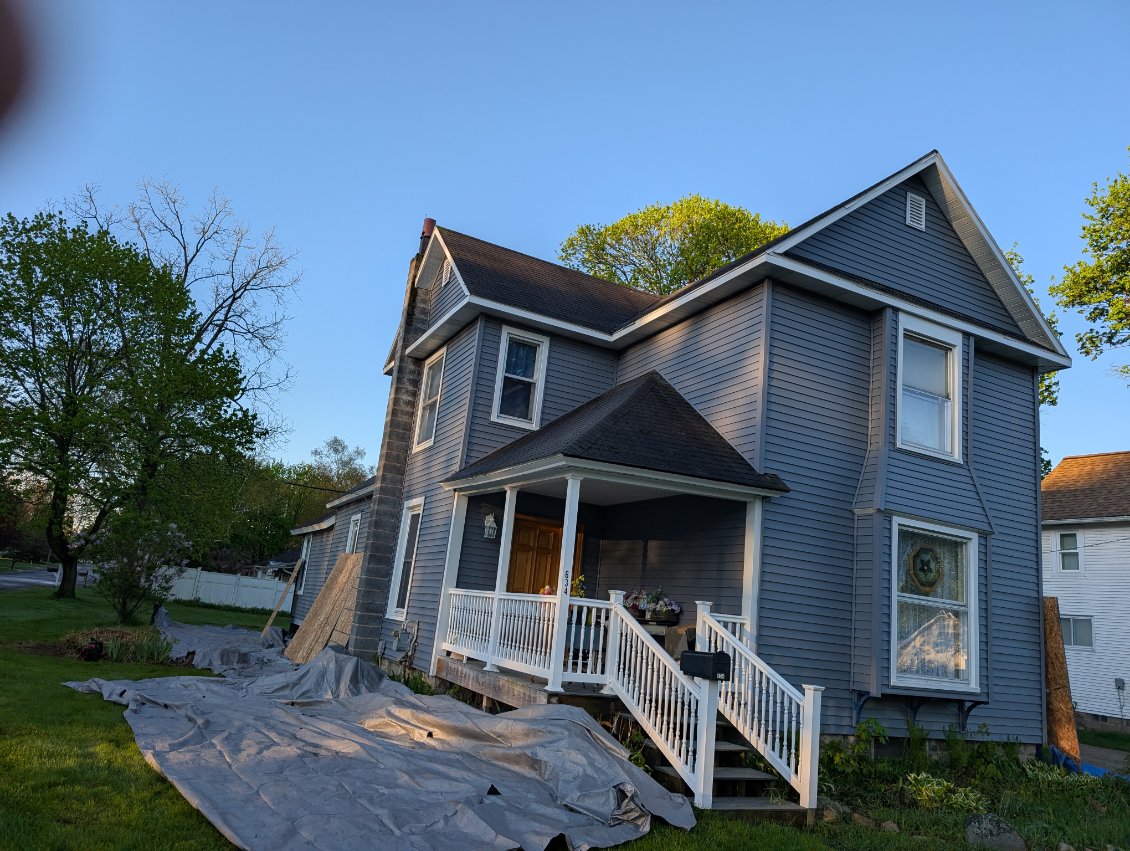 Mueller Construction roofing crew installing shingles on a residential roof