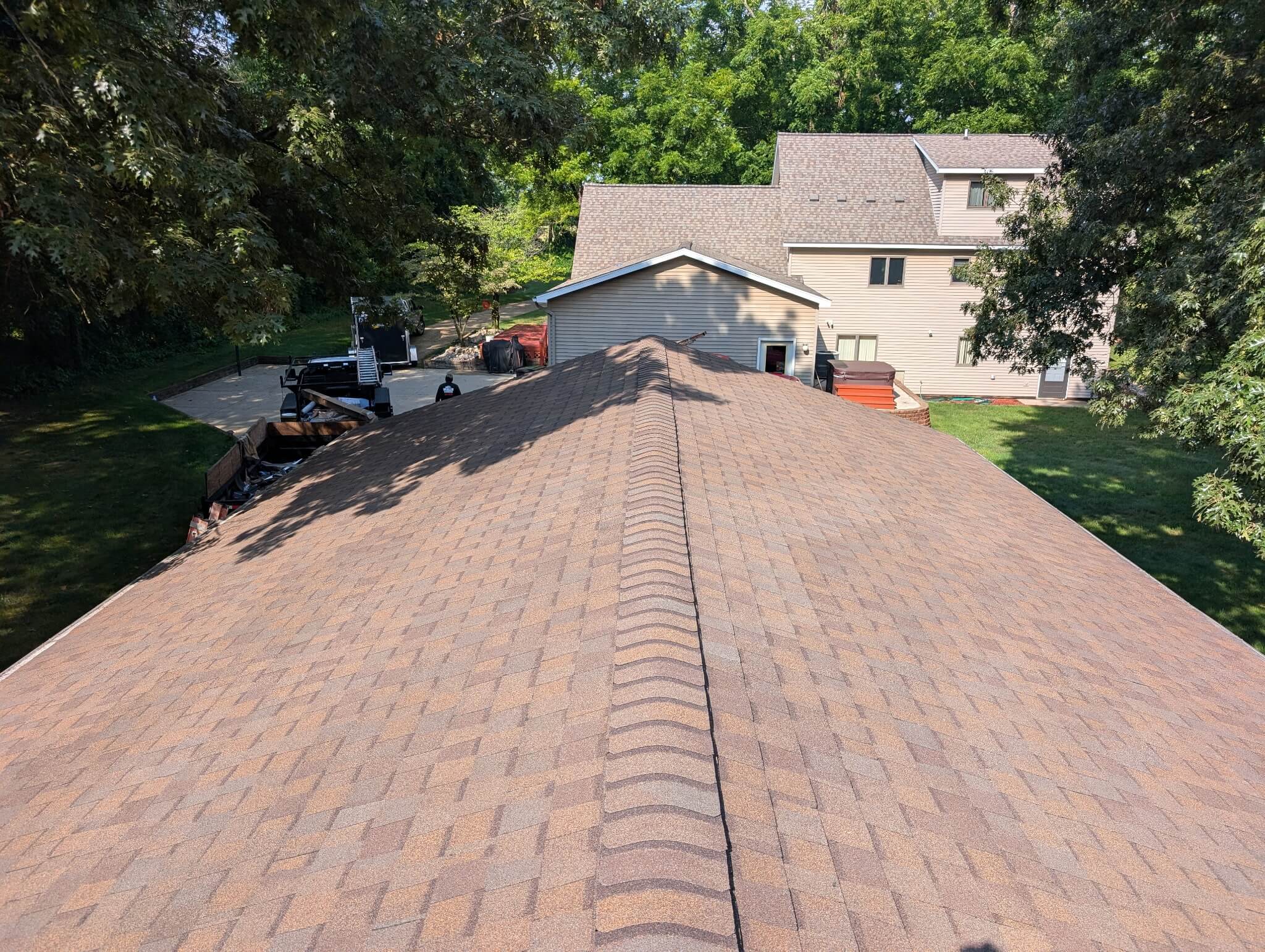 Newly installed residential shingle roof completed by Mueller Construction