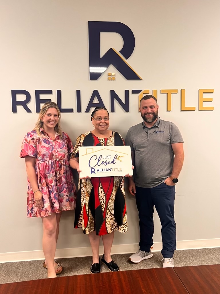 Channing Moore with clients at closing