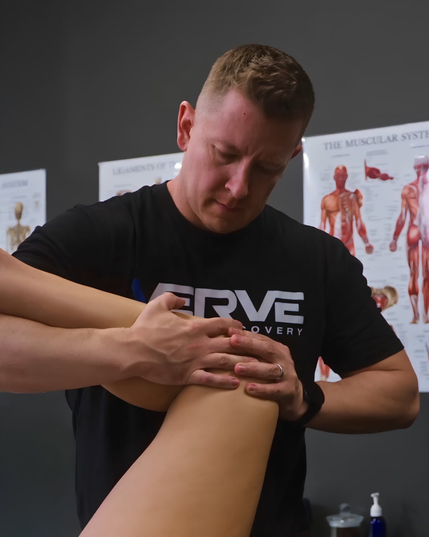 Joshua performing manual therapy on an athlete's knee
