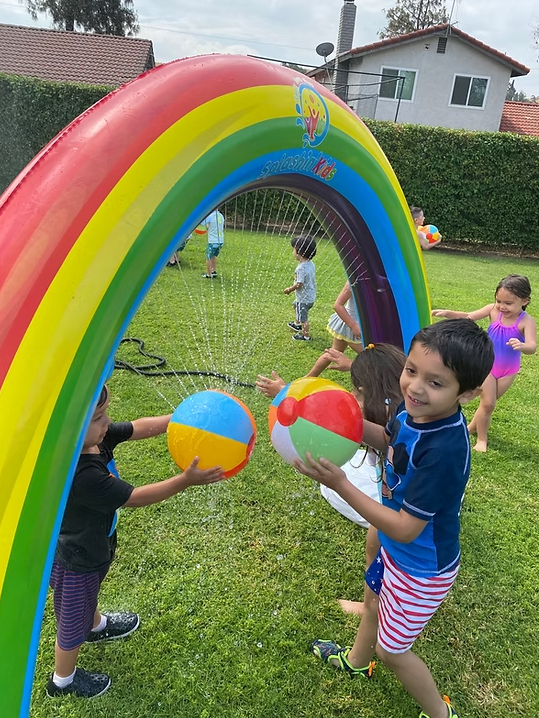Children playing together outdoors at summer camp