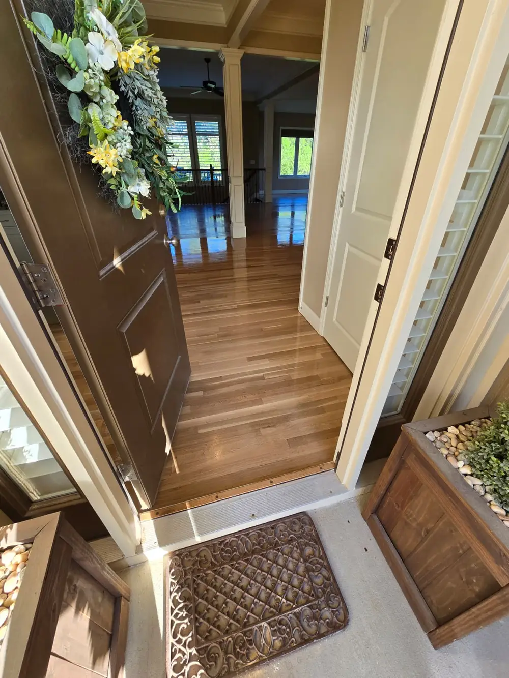 Refinished hardwood entryway with glossy finish